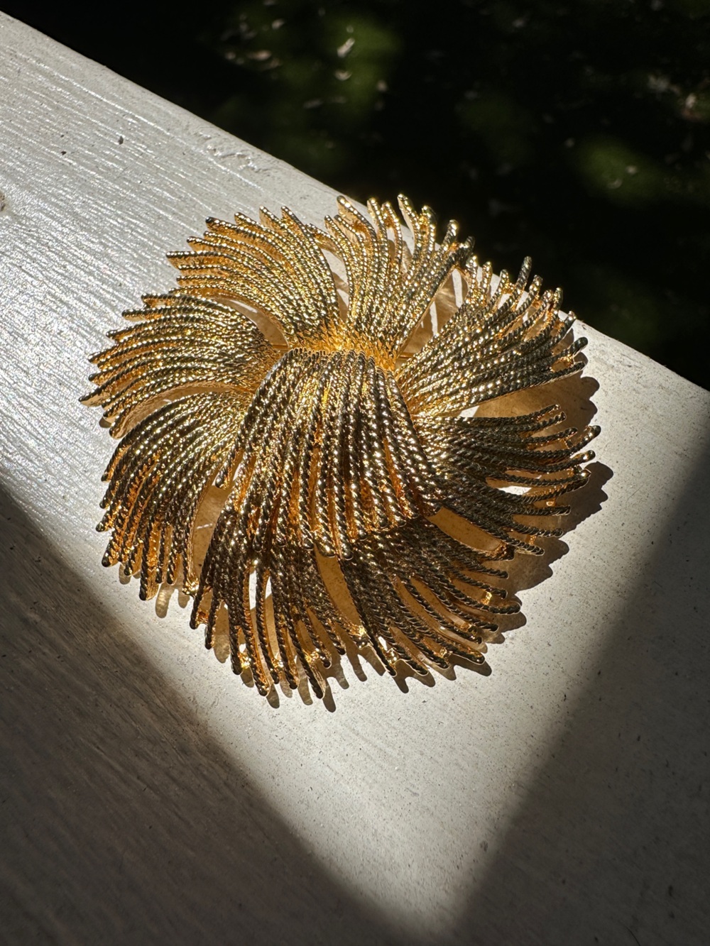 Vintage 1960s Monet "Cordelia" gold-tone starburst brooch.